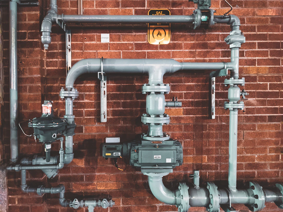 Clean copper pipe work on a brick wall
